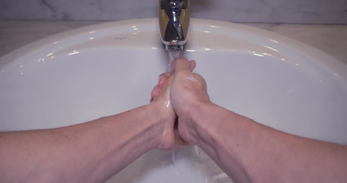 POV Man Washing Male Hand With Soap And Water Under Faucet.