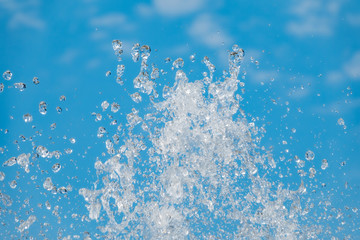 Splashes of water against the blue sky background
