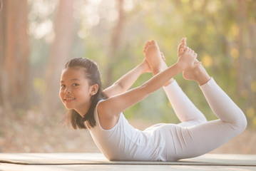 calmness and relax, female happiness.Horizontal, blurred background. little asian girl meditates...