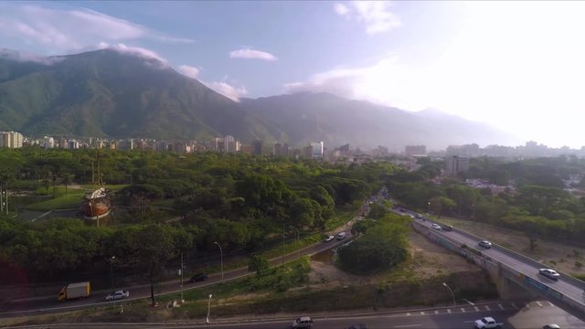 Aerial view over the Francisco Fajardo Highway, in Caracas, Venezuela, with the &Aacute;vila Mountain at the background.