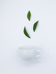 Top view mockup a cup of tea and tea leaf on the white desk. Free space for your text.
