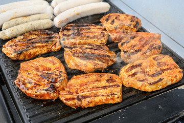 Barbecue grill bbq on coal charcoal grill with steaks bratwurst sausages and meat delicious summer meal