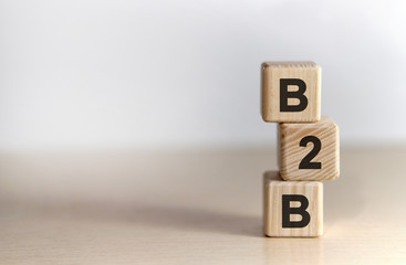 B2B - text on wooden cubes, on wooden background