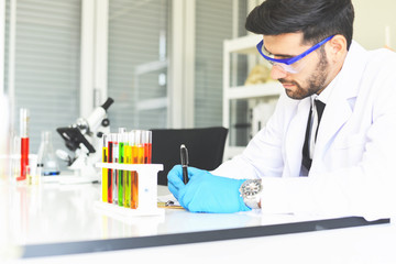 Man doctor as male scientist doing some research working conduct experiments in modern laboratory - Scientists in lab biochemistry genetics forensics microbiology and test tube