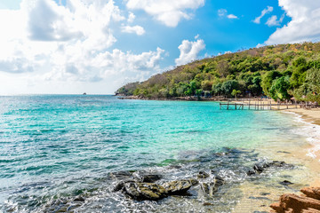 Fototapeta premium Sea waves on sand beach water and coast seascape rocky coast - View of beautiful tropical landscape beach sea island with ocean blue sky and resort background in Thailand summer beach vacation
