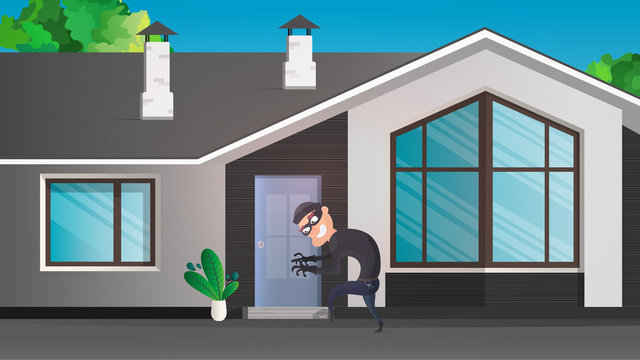 A thief sneaks into the house. The robber is trying to crack the door. Sign of a robbery. A surveillance camera recorded a thief. Security concept. 