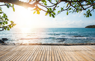 Terrace view sea with empty wooden table top on the beach landscape nature with sunset or sunrise - wooden bridge balcony view seascape idyllic seashore silhouette tropical tree summer vacation beach