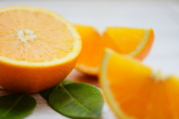 Orange fruit on wooden background / Fresh orange slice half and orange leaf healthy fruits concept