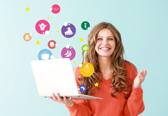 Portrait of happy young woman with laptop on color background - obrazy, fototapety, plakaty