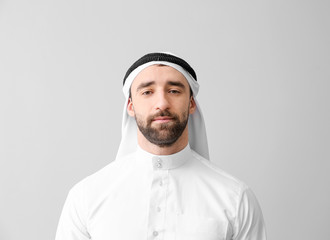 Handsome Arab man on grey background