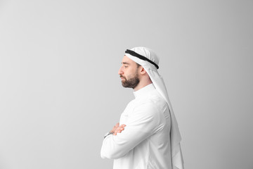 Handsome Arab man on grey background