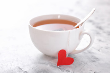 Cup of hot tea on white background