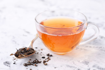 Cup of hot tea on white background