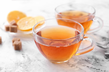 Cups of hot tea on white background