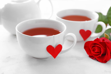 Cups of hot tea on white background