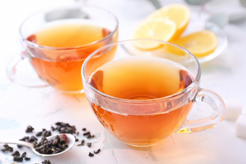 Cups of hot tea on white background