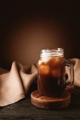 Mason jar of iced coffee on table