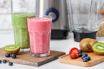 Glasses of healthy smoothie and ingredients on table
