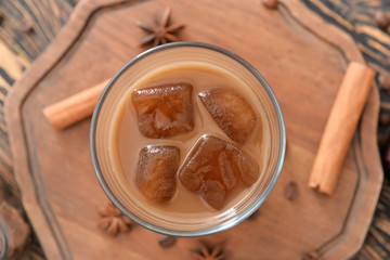 Glass of tasty iced coffee on table