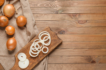 Composition with fresh raw onion on wooden table
