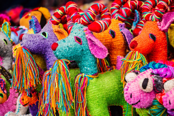 Colorful goats woven by hand in wool in outdoor exhibition. 