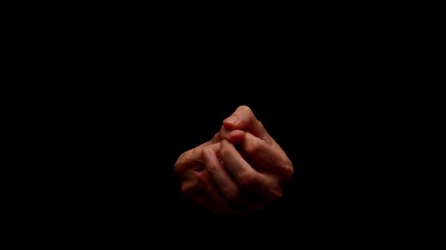 Male hands showing gesture isolated on black background