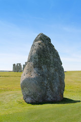View of Stonehenge with green meadow and blue sky on a sunny day in Spring, United Kingdom