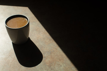 cup of coffee in window light