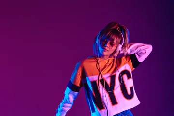 Fotobehang Happy girl wear glasses, headphone listen dance music at purple background. © insta_photos