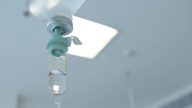 4K Closeup of IV drip in a hospital, Dripping beads of saline in an intensive therapy room