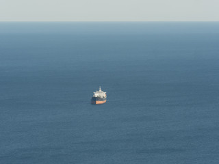 empty oil tanker alone in the middle of calm ocean - 330898629