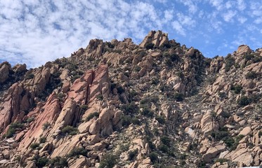 mountain and rocks with blue sky and some clouds