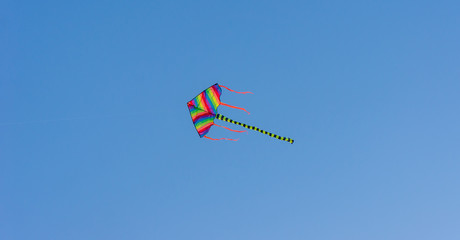 Colorful kite with blue sky background.