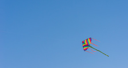 Colorful kite with blue sky background.