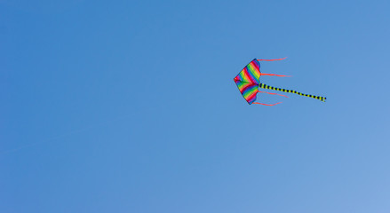 Colorful kite with blue sky background.