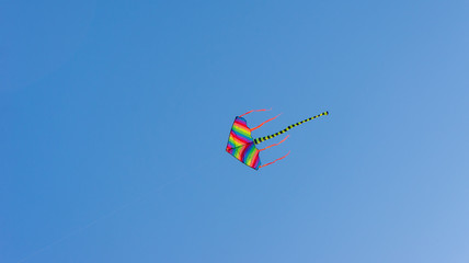 Colorful kite with blue sky background.