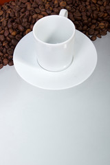 Coffee beans and a cup and saucer