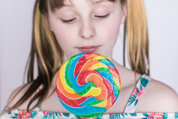 Fototapeta na wymiar Close up of young girl and lollipop