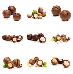 Macadamia nut with pieces and green leaves isolated on a white background