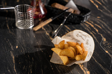 rustic potatoes garnish against a dark background in a bar