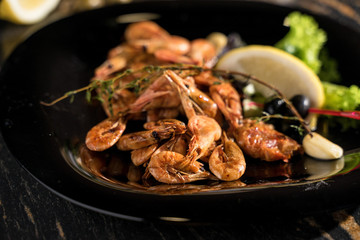 large shrimps, king prawns, black dish shrimp serving, boiled and fried shrimps, smoked shrimps, close-up