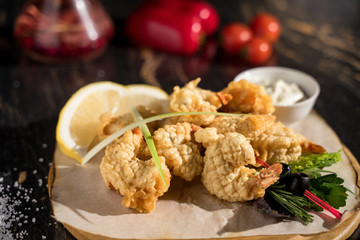 king prawns in batter served on a wooden plank