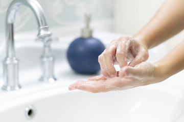 woman washing hands in bathroom