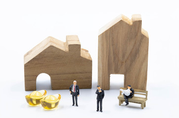 The miniature business man with the Gold in front of the building Land isolate on white background Investiment  Concept