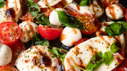 Mozzarella and cherry tomato, basil and balsamic vinegar salad. Italian cooking. Macro