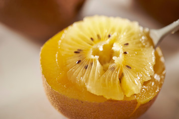 Eating gold kiwifruit with spoon