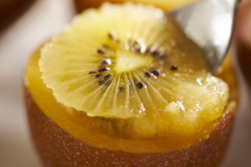 Eating gold kiwifruit with spoon