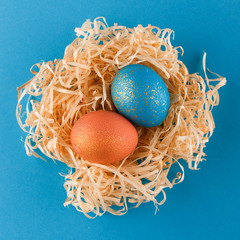 Easter eggs are painted blue with gold and orange gold.