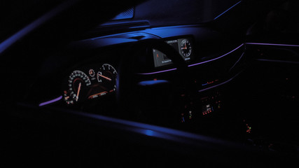 Interior luxury car in color lights and black background