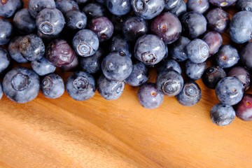 fresh blueberries on wooden table.  Texture blueberry berries. Copy space for your text. top view